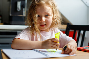 portrait of a girl painting in the kitchen.