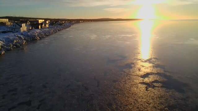 Winter sunset over the ocean in Matane, Quebec, Canada.