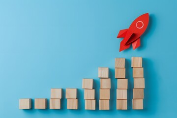 Business Growth with Wooden Block Graph and Red Rocket