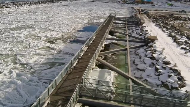 Drone shot of the Matane River in Canada on a sunny day during the winter.