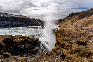Majestic waterfall cascading down the mountainside. Iceland