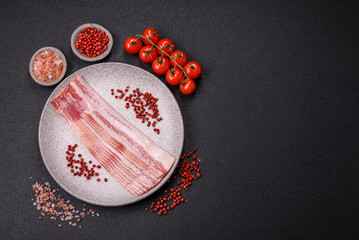 Delicious bacon in the form of slices with salt, spices and herbs