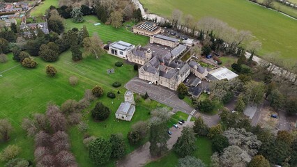 an aerial view of a house in the middle of green grass