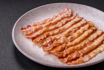 Delicious bacon in the form of slices with salt, spices and herbs