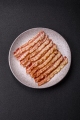 Delicious bacon in the form of slices with salt, spices and herbs