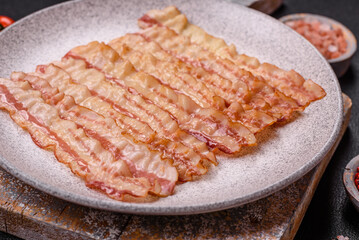Delicious bacon in the form of slices with salt, spices and herbs