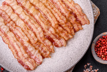 Delicious bacon in the form of slices with salt, spices and herbs
