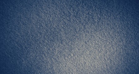 Navy blue background texture with white vignette. Blue felt fabric background with copy space for design. 