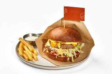Hamburger with two beef patties served with fries and sauce