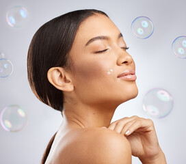 Studio, bubbles and beauty for calm woman, hands and cosmetic on white background. Cosmetology, smile and confidence for relax female model, dermatology and salon treatment for skincare or wellness