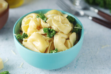 A bowl with Italian dumplings - tortellini	