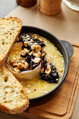 Torched Camembert with currant jam, hazelnuts and toasts