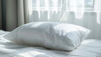 White pillow on bed with sunlight filtering through sheer curtains