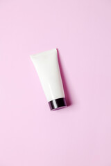 White sunscreen bottle on pink background. Product concept. Sunscreen concept. copy space.