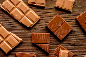 black chocolate pattern on wooden background top view