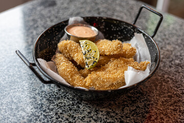 golden deep-fried battered chicken nuggets.succulent chicken chunks ensconced in a delectable...
