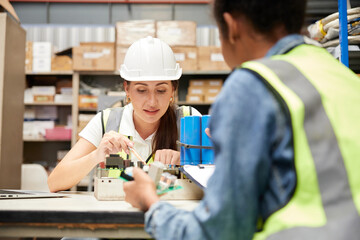 factory workers checking and fixing small machine or mainboard in the factory