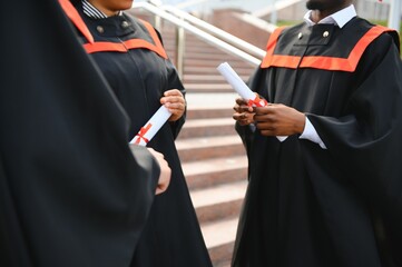 Close up people graduating with diplomas
