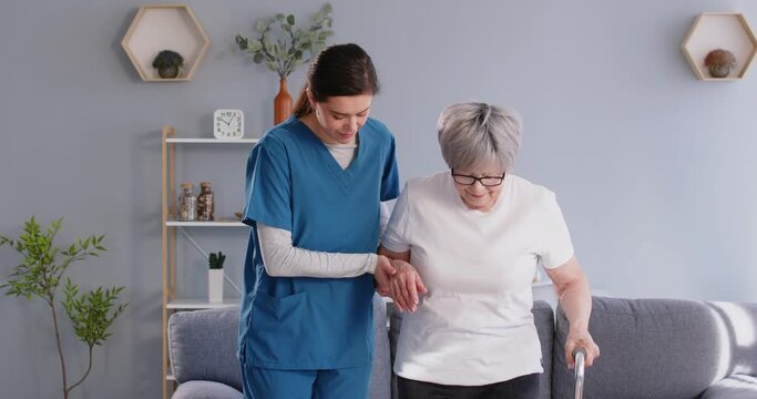 Senior nursing, health care of elderly people, young female geriatric nurse helping walk. Caregiver looking after sick old woman, healthcare professional caring, health care assistant home health aide