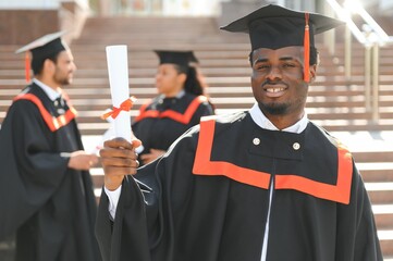 Happy graduate. Happy African man in graduation gowns