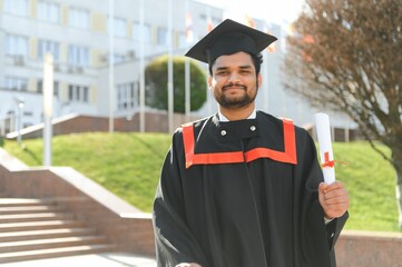 education, graduation and people concept - happy Indian Male graduate student