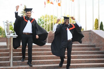 Two friends are university graduates. Indian and African graduates