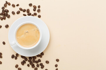 Cup of coffee on color background, top view