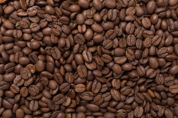 Roasted coffee beans as background, top view