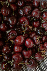 Freshly washed cherries glisten with the promise of summer's sweetness