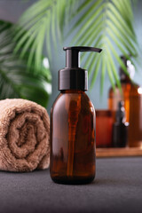 A brown glass dispenser cosmetic bottle for body care product mock-up in tropical spa interior