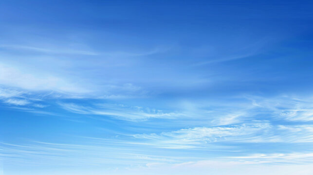 Serene blue sky with wispy clouds. Vibrant blue sky adorned with wispy white clouds, creating a tranquil and ethereal atmosphere.