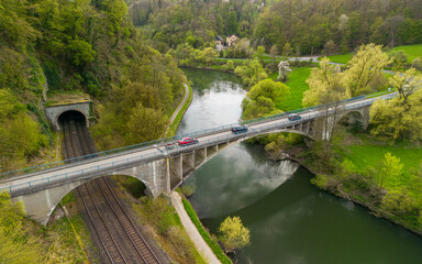 Obraz premium Bridge going over the train tracks and the river