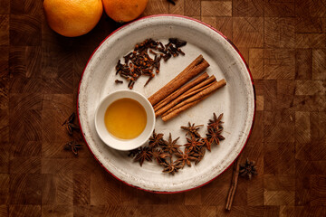Top view of a wooden board with ingredients for mulled wine on a table