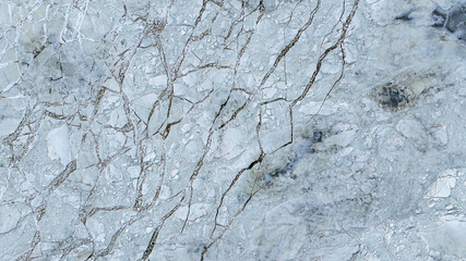 Top-down view to the textures and patterns of the cracked sea-ice formations