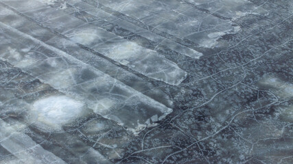 Top-down view to the textures and patterns of the cracked sea-ice formations