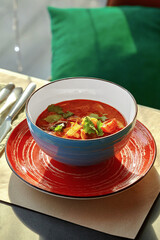 Bowl of savory Thai tom yam soup with seafood and herbs
