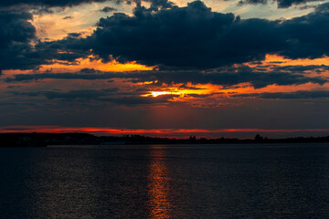 Dark, cloudy sunset casting a dramatic light on the sky