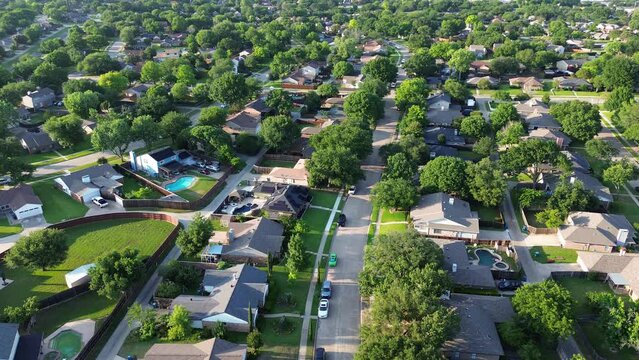 Large fenced backyard of suburban houses with parallel residential streets and back-alley suburbs Dallas Fort Worth metro complex, medium density subdivision large lots size, warm light, flyover