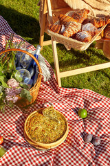 Savory quiche, sweet croissants. fruits ans wine for summer picnic