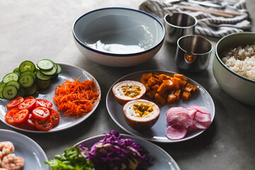 Poke bowl with shrimp prepared by the chef containing white rice, mango, avocado, tomato, etc.