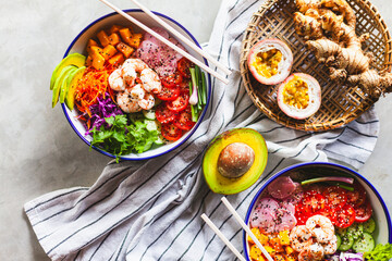 Poke bowl with shrimp prepared by the chef containing white rice, mango, avocado, tomato, etc.