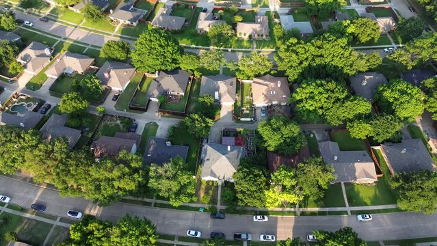 Upscale Dallas suburbs residential neighborhood subdivision with parallel residential streets, back alley, row of single-family houses outside DFW Fort Worth metro complex, swimming pool, flyover