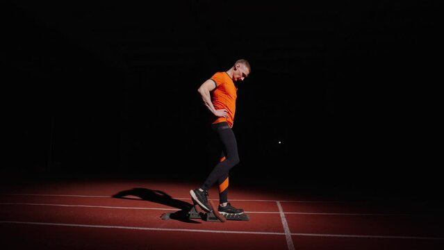 Tired Sportsman Training Alone In Stadium In Night, Young Adult Athletic Man Standing In Low Start