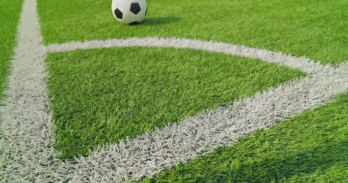 Soccer field impressions - Ball out of play - Soccer ball kicked out of the soccer field, rolling over the corner arc and the goal line - Slow-mo