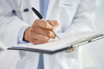 Hands, doctor and writing on paperwork in hospital for insurance details, consent form and...