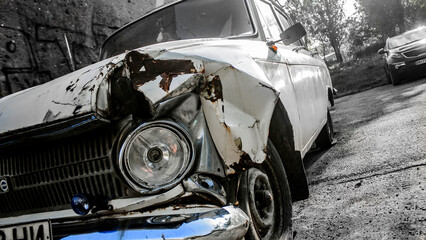 Destroyed in front of a white car