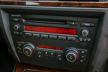 Car radio in car interior with red screens