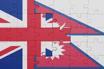 puzzle with the colourful national flag of nepal and flag of great britain.