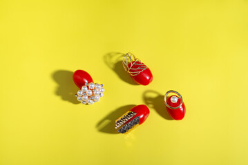 Seedless fruit, ripe red tomatoes in a group with gold ring on a vibrant yellow background