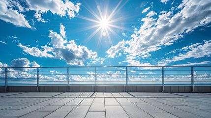 Empty rooftop with ocean and sky view. Sunlit empty rooftop with railing, overlooking a calm blue ocean with clouds and blue sky. Ideal for architecture, travel, and leisure concepts.